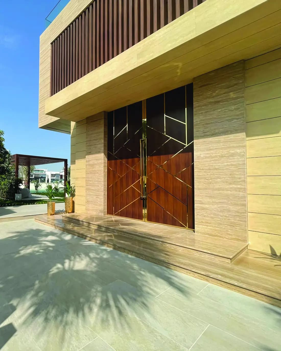 Villa entrance with lit timber cladding